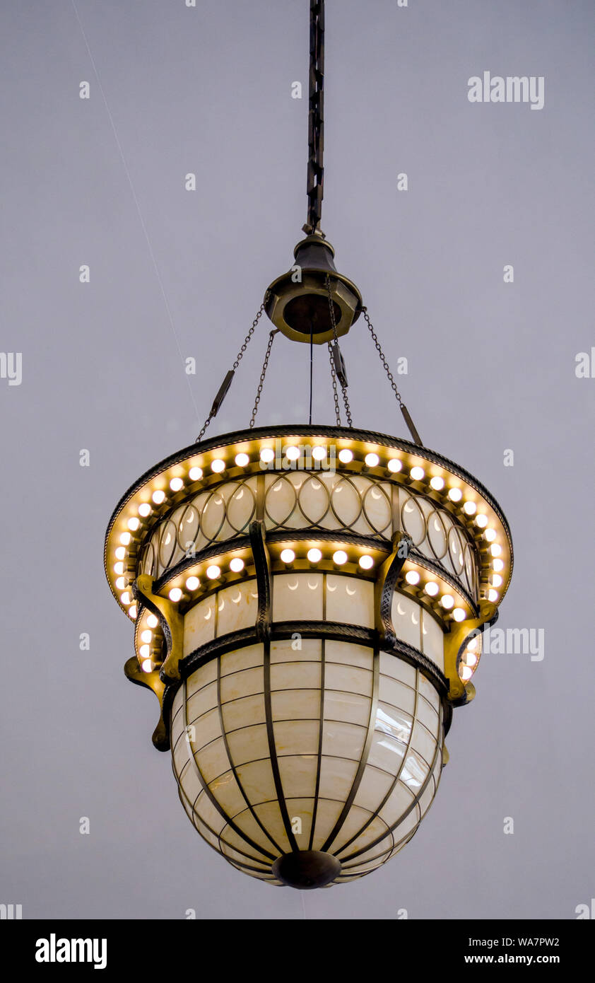 A beautiful antique pendant lamp hangs from a ceiling in a commercial building Stock Photo Alamy