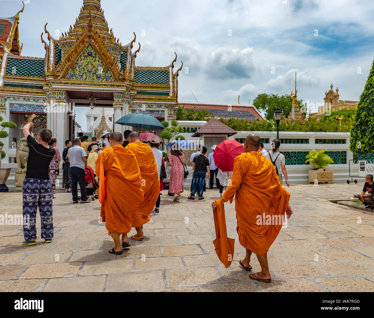 Bangkok, Thailand - July 2019: Unidentified Buddhist monks and international tourists are visiting The Royal Palace Stock Photo