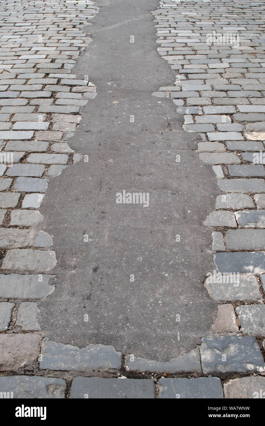 tarmac repair to cobbles on cobbled street - Stirling, UK Stock Photo