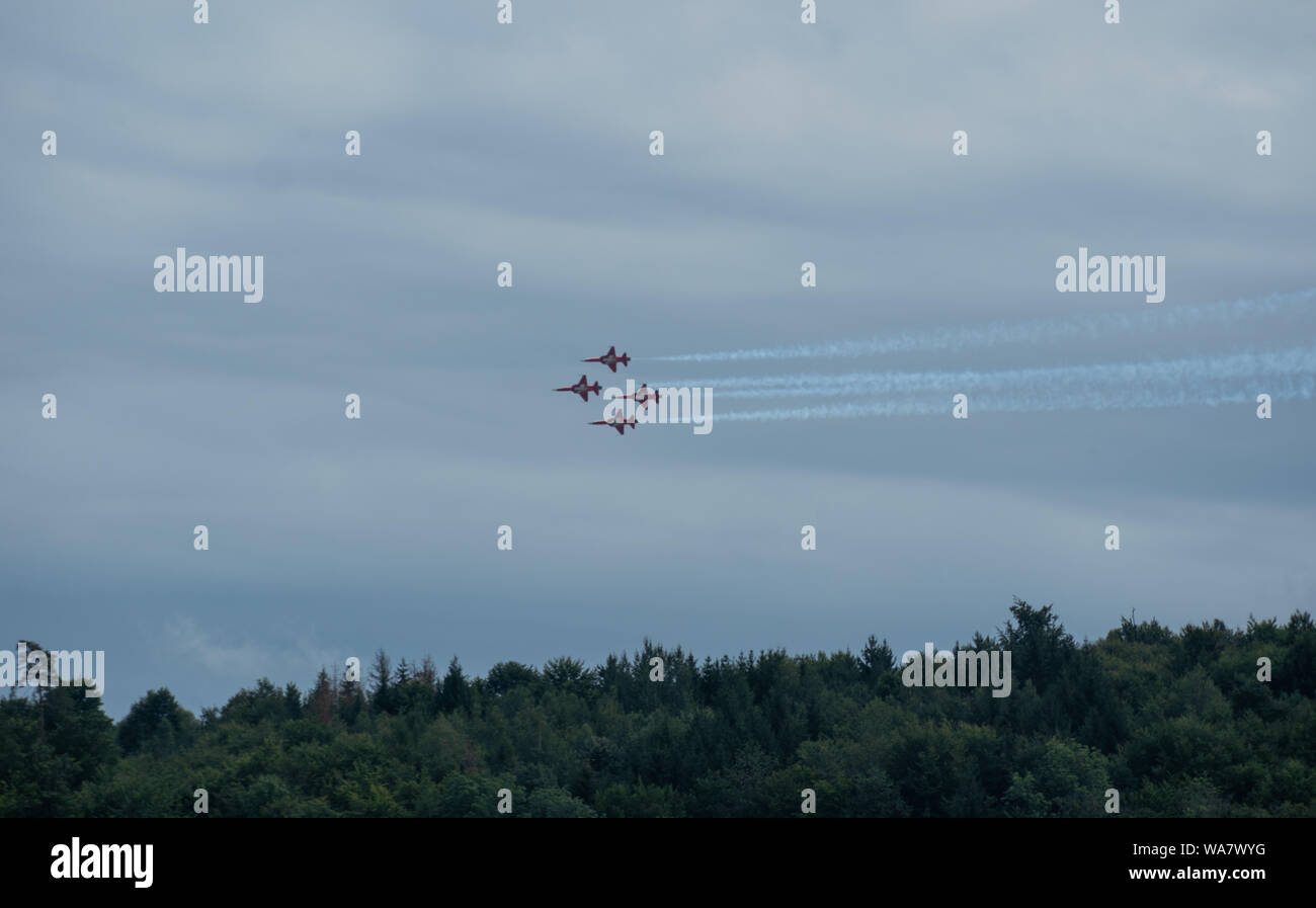 Patrouille Suisse in Formation flying over the woodland of Habsburg over Brugg during the airshow of convoy to remember at Birmenstorf 2019 Stock Photo
