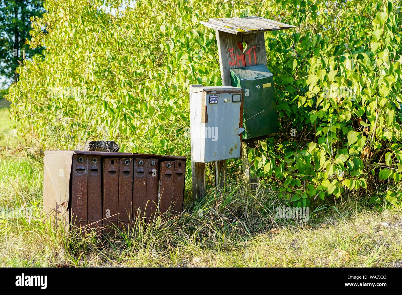 old rusty mailboxes in rural area on a green background Stock Photo Alamy