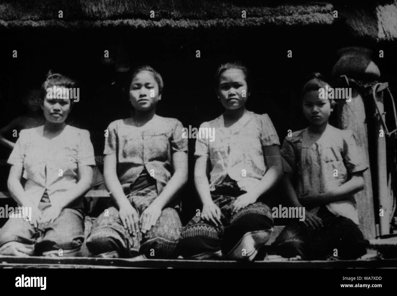 AJAXNETPHOTO. 1953-1957 (APPROX). INDO CHINA. VIETNAM. (IN-COUNTRY LOCATION UNKNOWN.) -  GROUP OF GIRLS POSE FOR THE CAMERA ON VERANDAH OF HOUSE ON STILTS. PHOTO:JEAN CORRE/AJAXREF:RX7 191508 226 Stock Photo