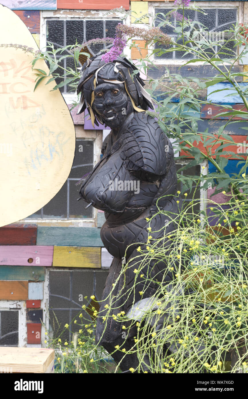 woman made from used car tires in the garden. Stock Photo