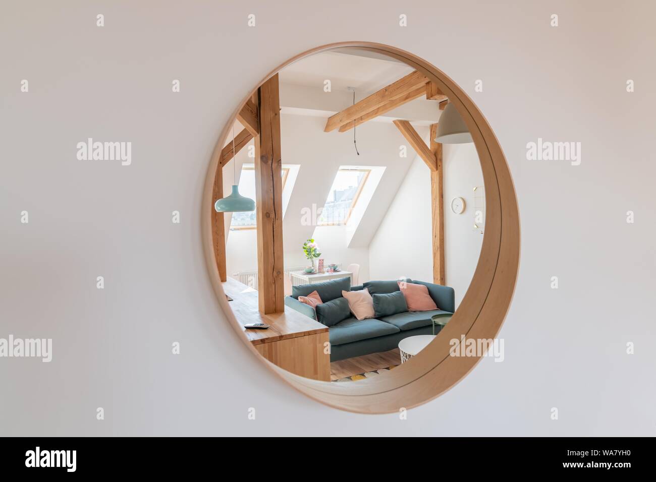 Round mirror on the living room wall Stock Photo - Alamy