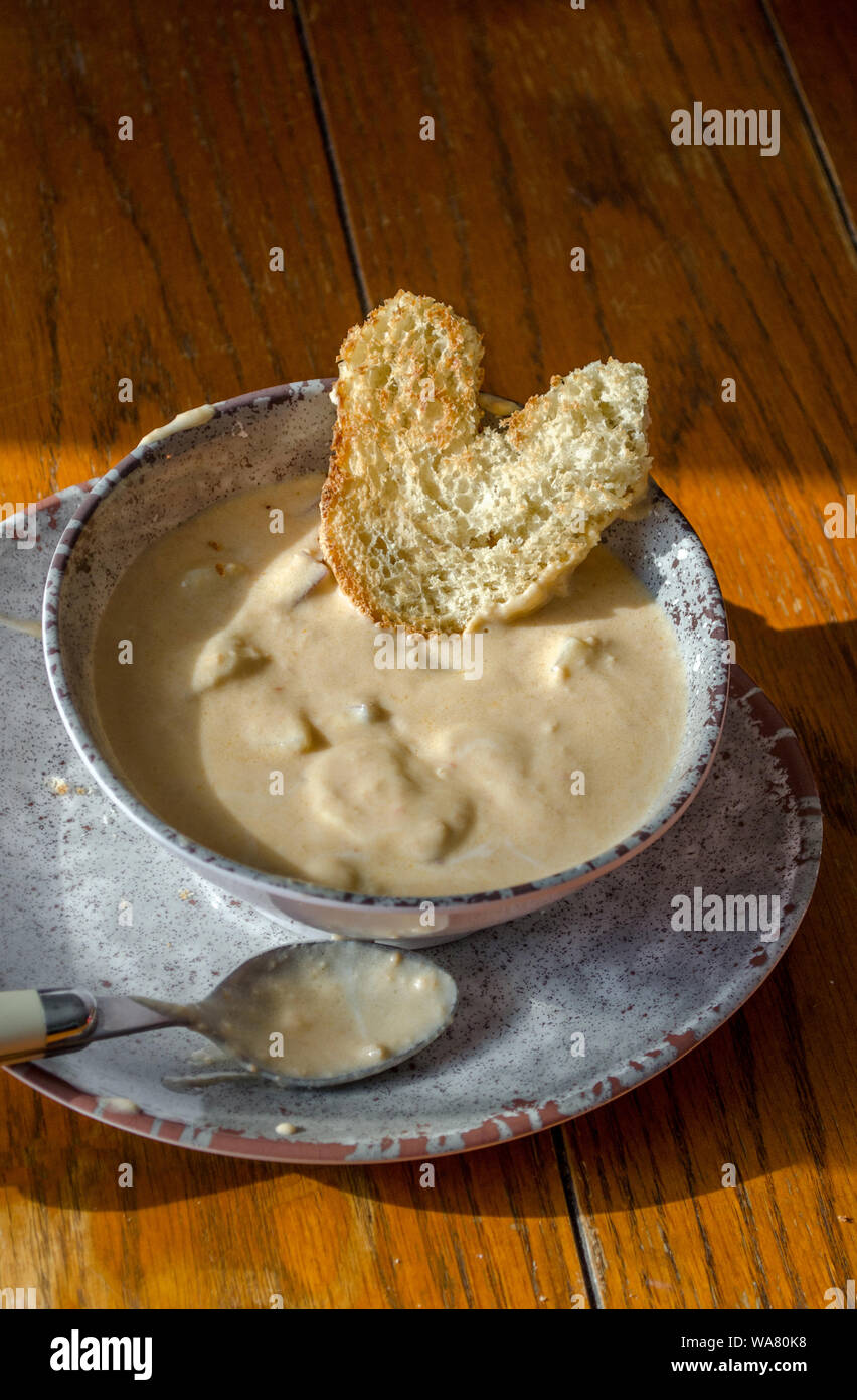 Chunky Potato Soup In A Rustic Bowl And Plate Is Hearty Comfort