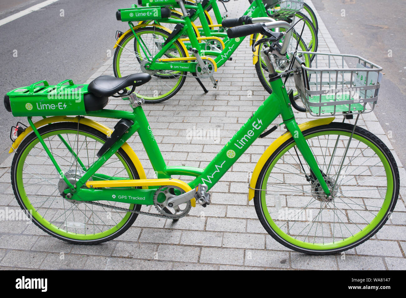 London, UK - August  2019: Dockless Lime-E green electric bike on a street in central London. Lime is a Californian Bike sharing transportation compan Stock Photo