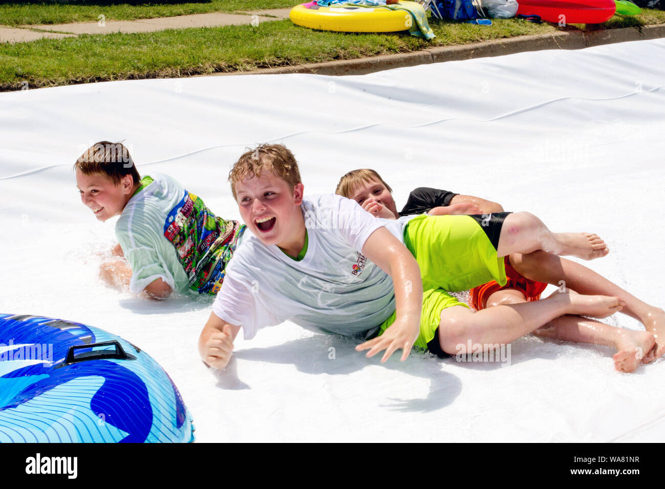 Aug 2017 Buchanon Michigan USA; boys laugh as they wipe  out at a water event called Thrill on the Hill Stock Photo