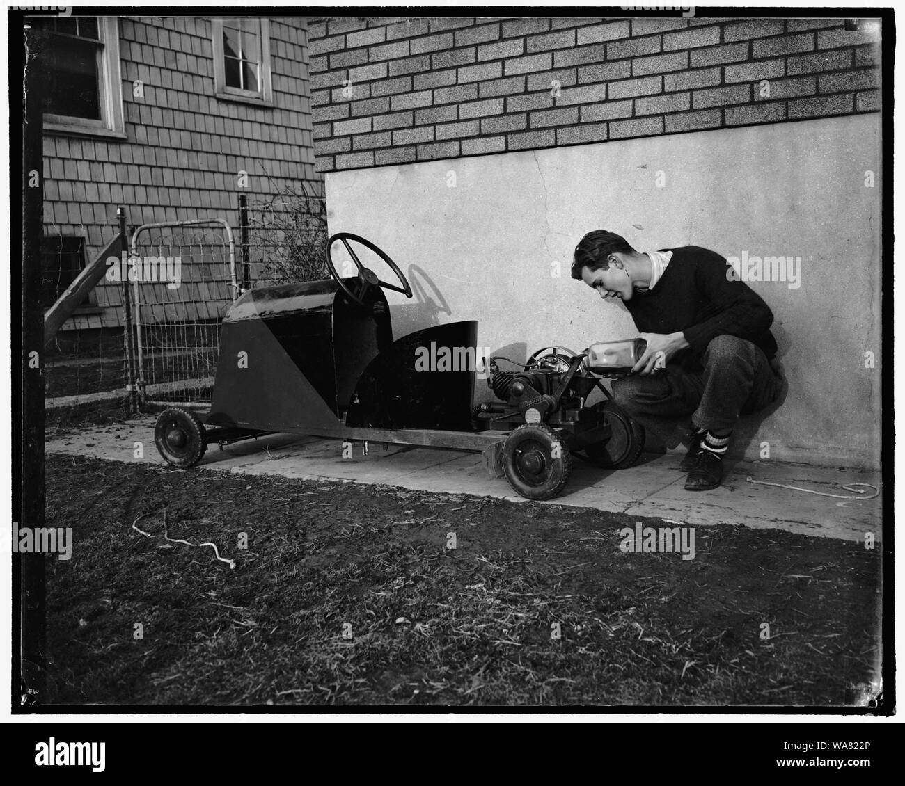 Builds own Jalopy. Washington, D.C., Feb. 2. Thirty dollars was all it cost Robert Preston, 16-year-old high school senior, to build this midget automobile. Weighing approximately 250 pounds, the 'jalopy' is powered with a washing machine motor of 3-4 horsepower and has a maximum speed of 20 miles an hour. His license tags for this year will cost 32 cents, 2-2-39 Stock Photo