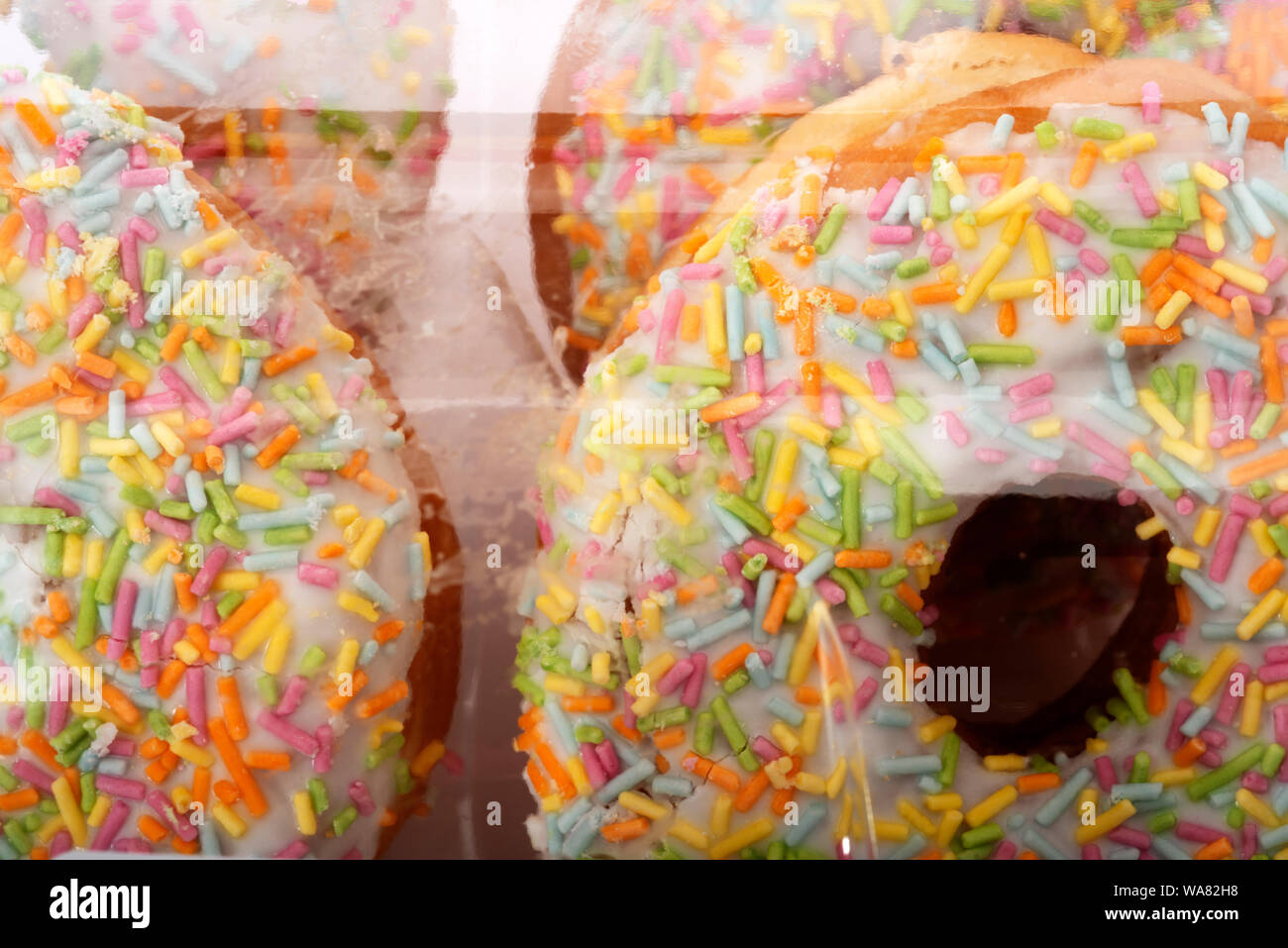 Ring doughnuts with rainbow sprinkles Stock Photo Alamy