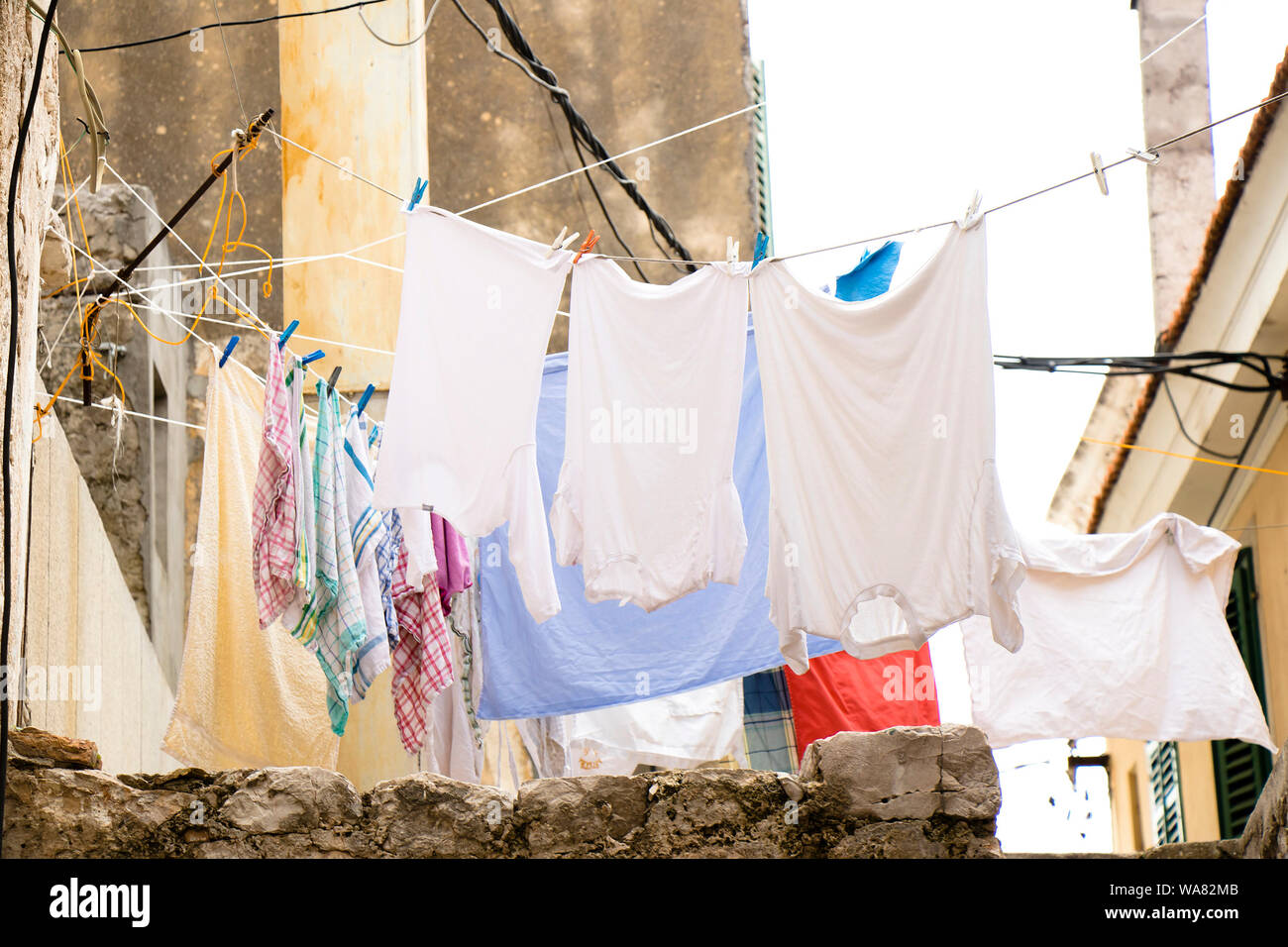 Washing Line With Drying Clothes In Outdoor. Clothes Hanging On