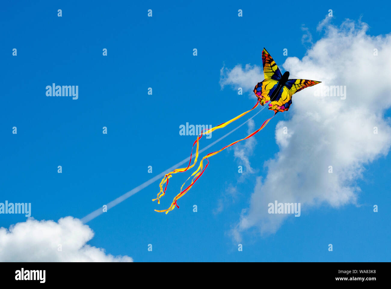 butterfly kite flying in the clouds Stock Photo