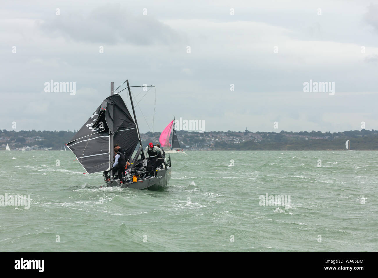 The Solent, Hampshire, UK; 16th August 2019; Crew Attempt Repairs on a dismasted Yacht Stock Photo