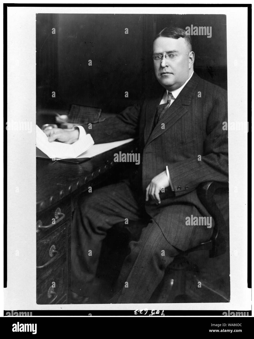 Byron Bancroft Johnson, threequarter length portrait, seated at desk