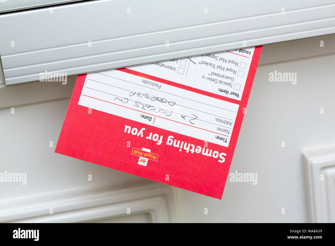 Royal Mail failed delivery note in letterbox Stock Photo