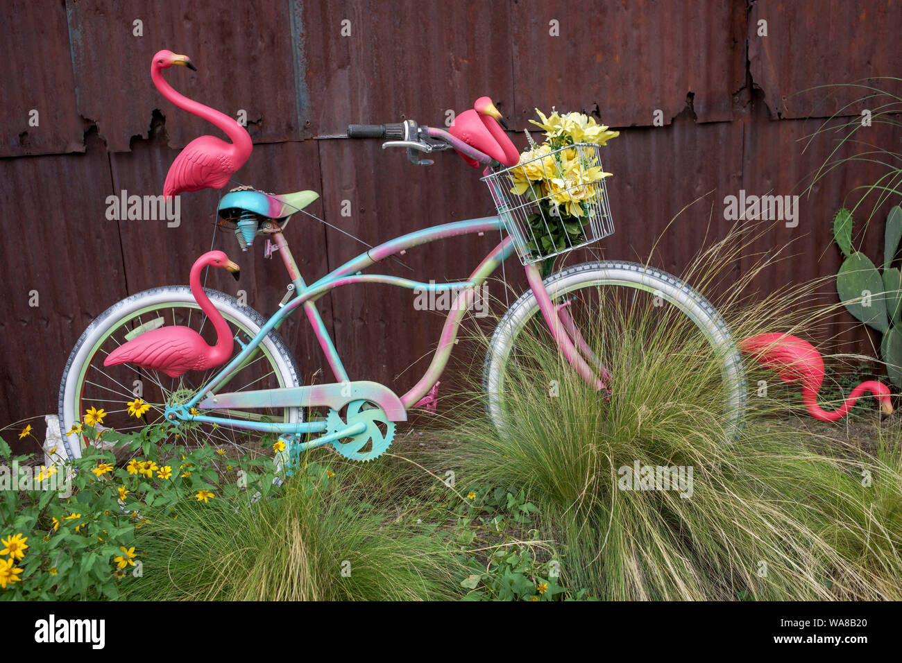Painted bicycle and Made in China flamingos on display in a street of Alpine, West Texas Stock Photo
