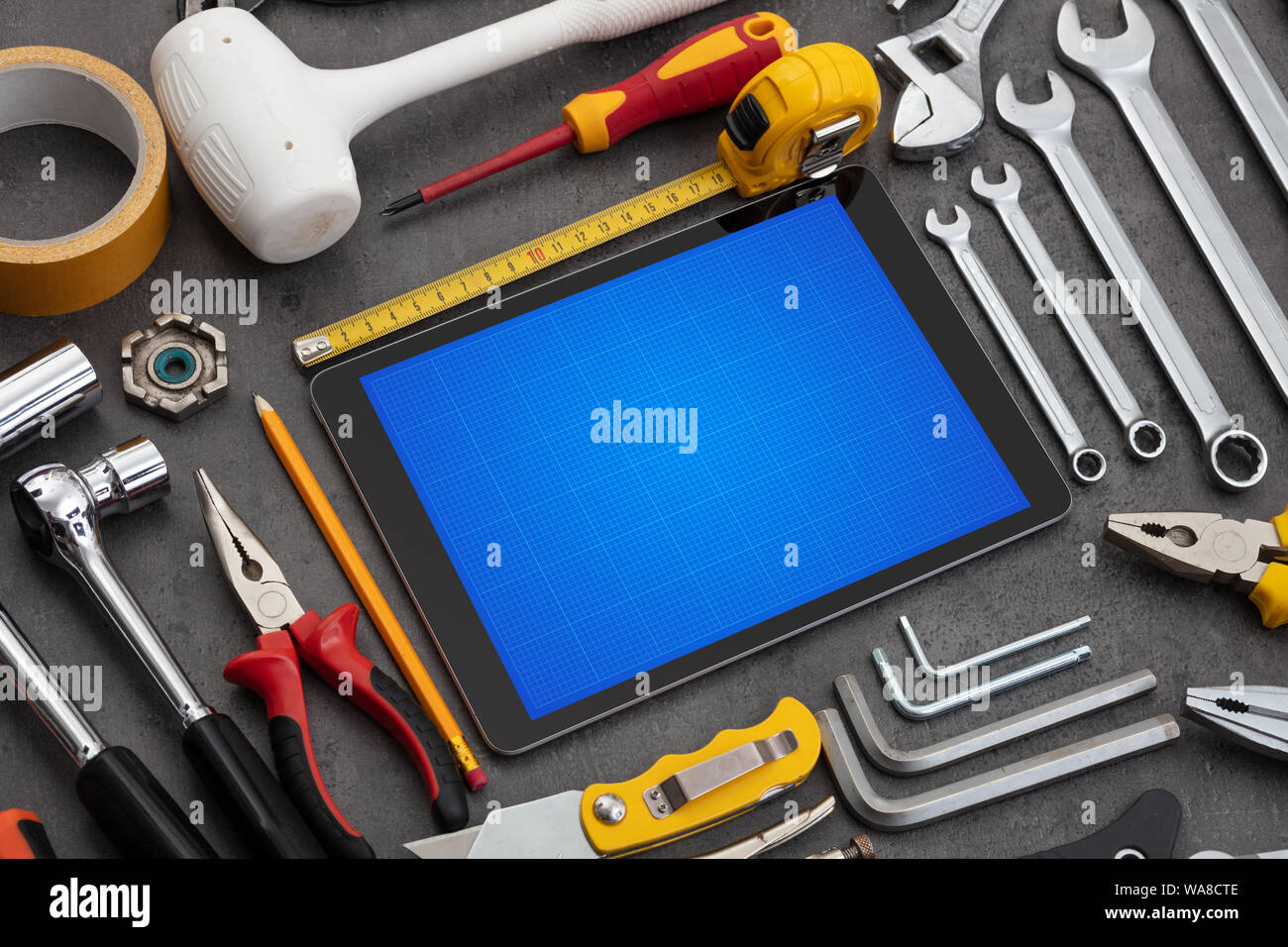 Household tools and tablet with grid screen concept Stock Photo