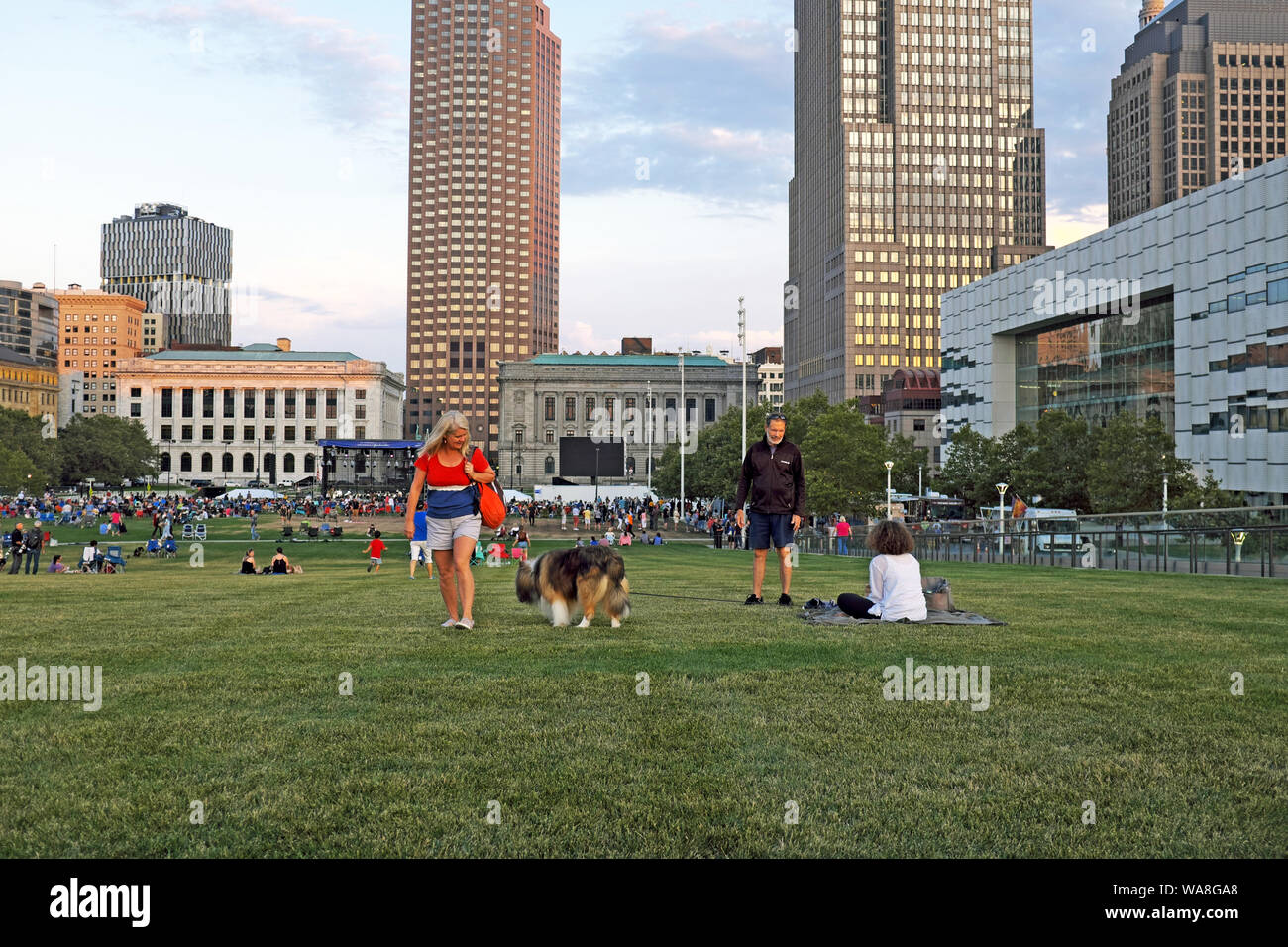 Summertime events in downtown Cleveland, like the Cleveland Orchestra, draw crowds to the grassy knoll, Mall B, to the outdoors and weather. Stock Photo