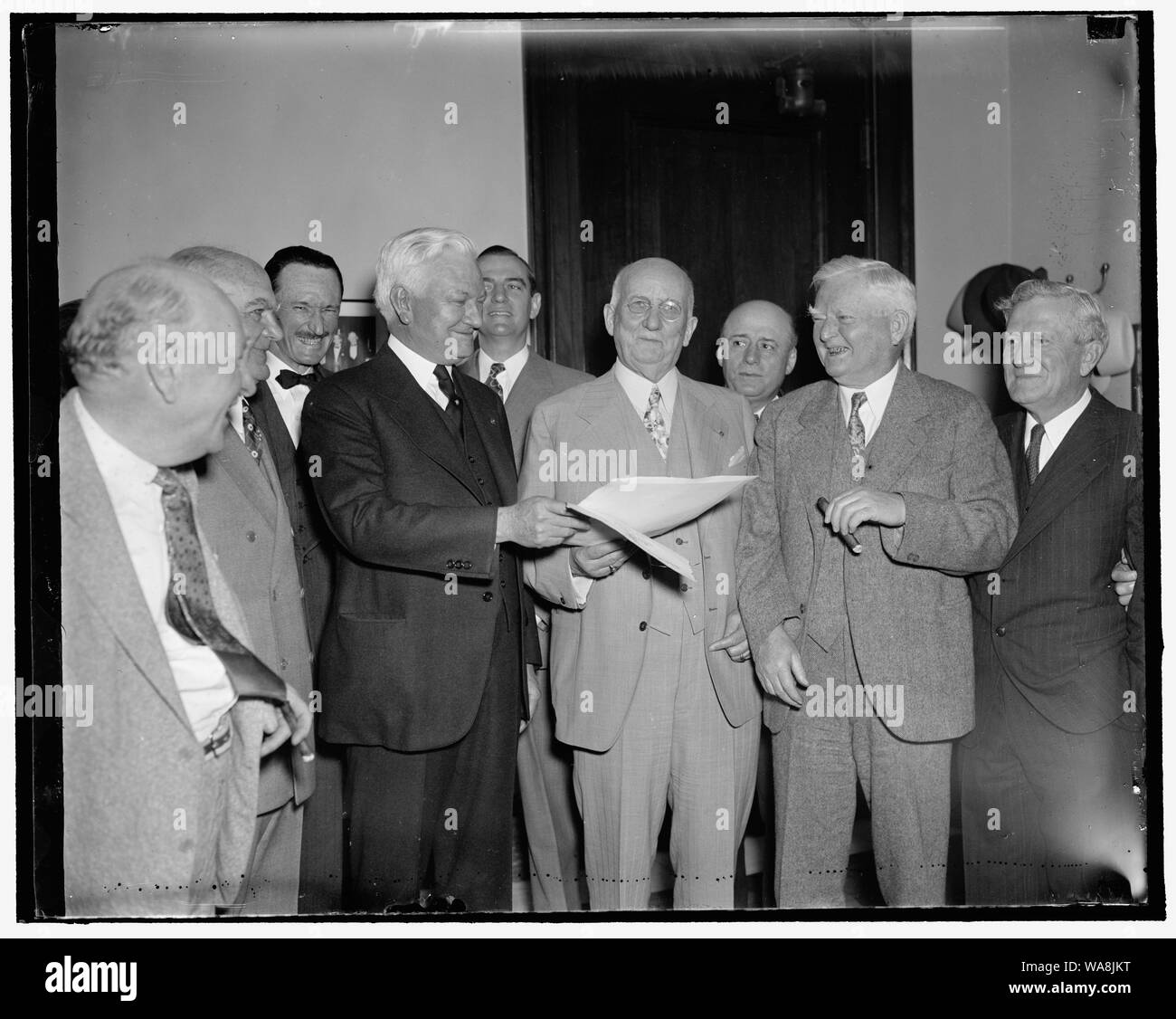 Canadian named official of Dallas exposition. Washington, D.C., May 5. Vice President Garner today presented Capt. J.W. Flanagan, Texas millionaire and Canadian sportsman, with the Commission of Director General of Foreign participation for the Pan American exposition to be held at Dallas this summer. Capt. Flanagan will sail May 8 for Colombia where he will begin a tour of South America to interest Latin-American sportsmen in raising funds to bring Latin athletes to Dallas for the Inter-American Sports Show. In the photograph, left to right: Roy Miller, of Houston; Rep. Albert Thomas, of Texa Stock Photo