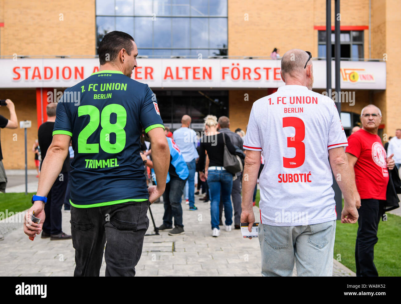 (190819) -- BERLIN, Aug. 19, 2019 (Xinhua) -- Two fans of Union Berlin prepare to enter the Stadion An der Alten Foersterei (Stadium at the old forester's house) before the first German Bundesliga match in the club's history against RB Leipzig in Berlin, capital of Germany, on Aug. 18, 2019. (Photo by Kevin Voigt/Xinhua) Stock Photo