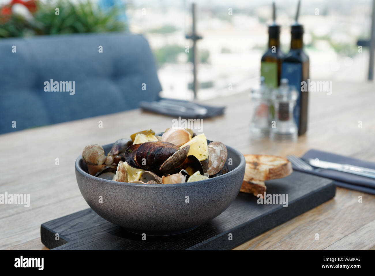 Clams and mussels stew in clay pot served with croutons Stock Photo Alamy
