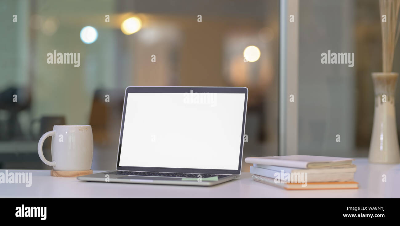 Open blank screen laptop computer in modern home-office and copy space ...