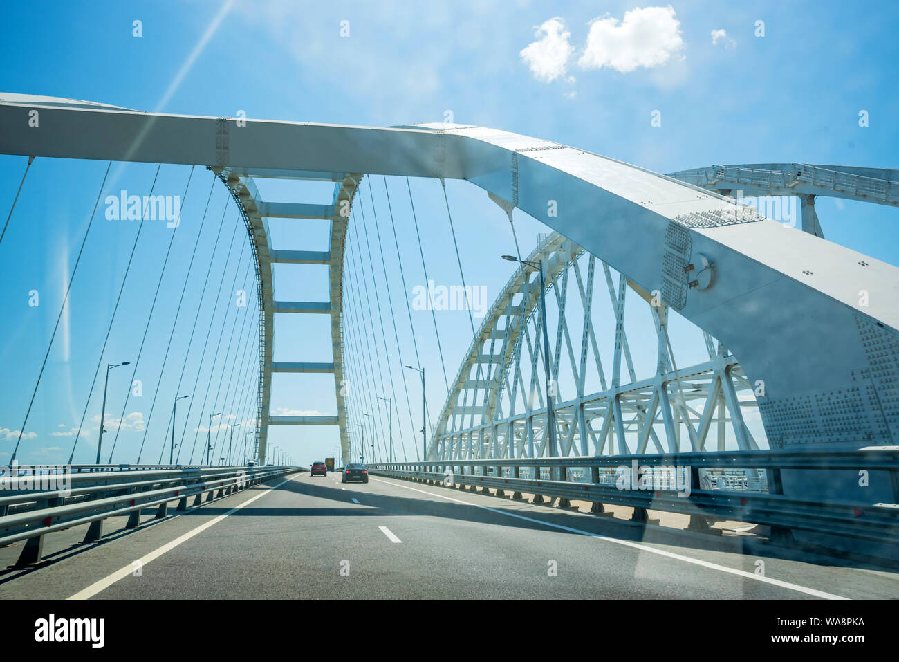 KERCH, RUSSIA - 5 AUGUST 2019: Cars go on the Crimean automobile bridge connecting the banks of the Kerch Strait: Taman and Kerch. Sunny summer day Stock Photo