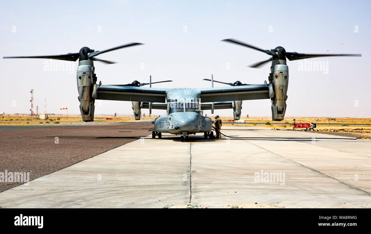 U.S. Marines with Marine Medium Tiltrotor Squadron (VMM) 364, attached to Special Purpose Marine Air-Ground Task Force-Crisis Response-Central Command, refuel a MV-22 Osprey during an Emergency Response Exercise in Kuwait, Aug. 16, 2019. A Marine Air Ground Task Force is specifically designed to be capable of deploying aviation, ground, and logistics forces forward at a moment’s notice. (U.S. Marine Corps photo by Sgt. Kyle C. Talbot) Stock Photo