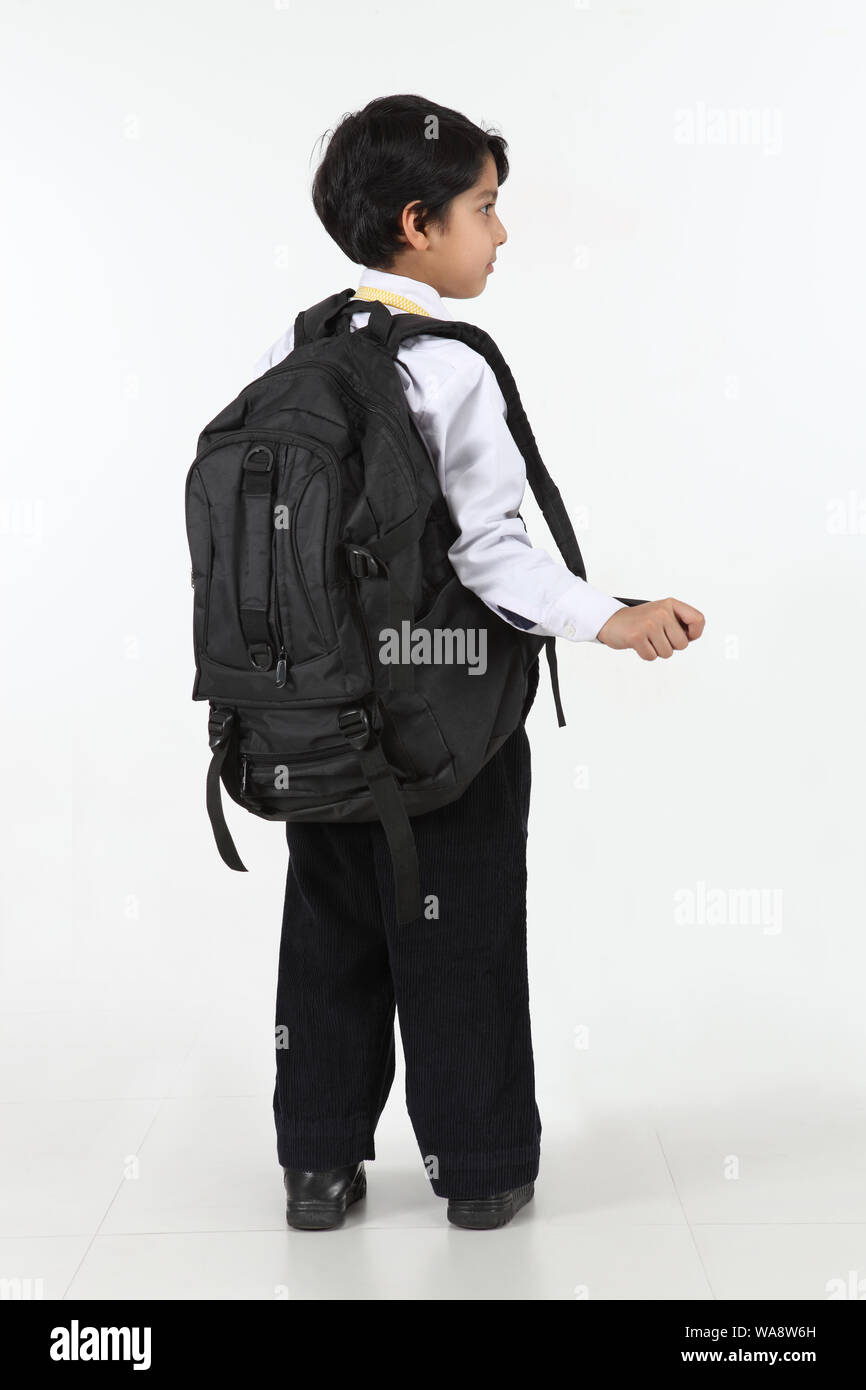 Schoolboy standing with his backpack Stock Photo