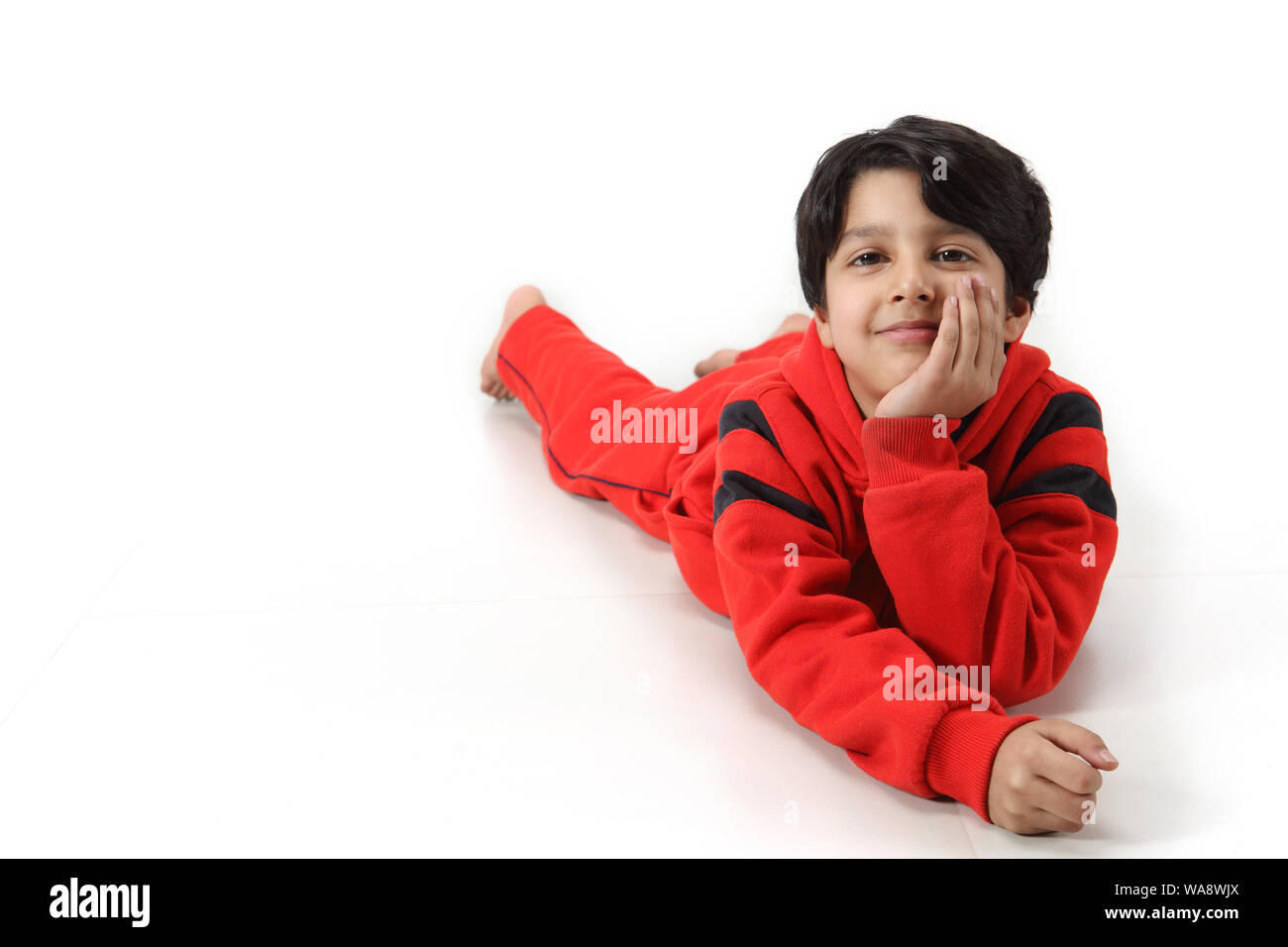 Boy lying down on floor Stock Photo Alamy