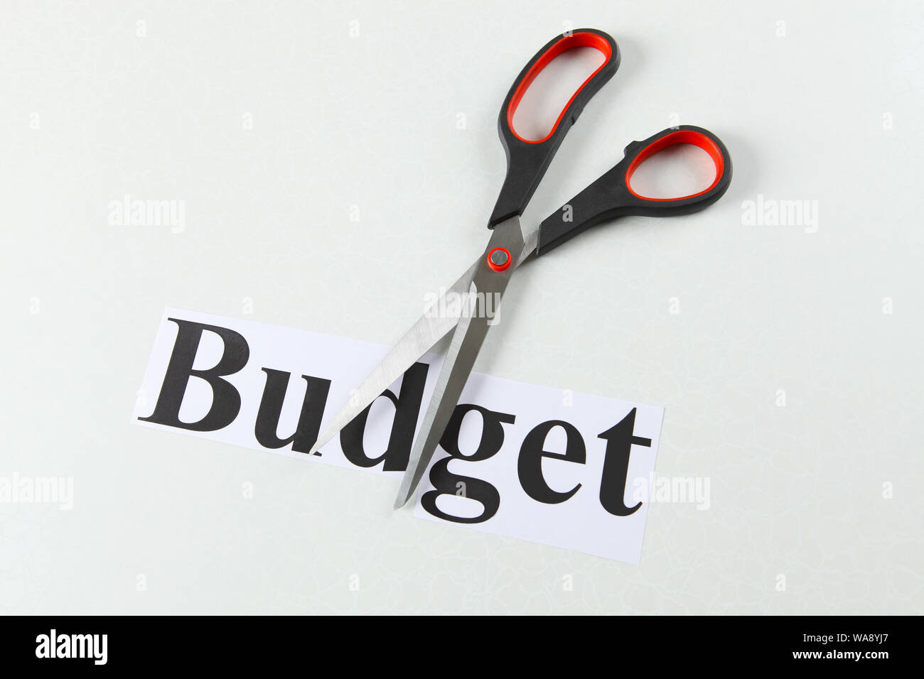 Budget cutting with pair of scissors representing concept "Cost Cutting Stock Photo Alamy