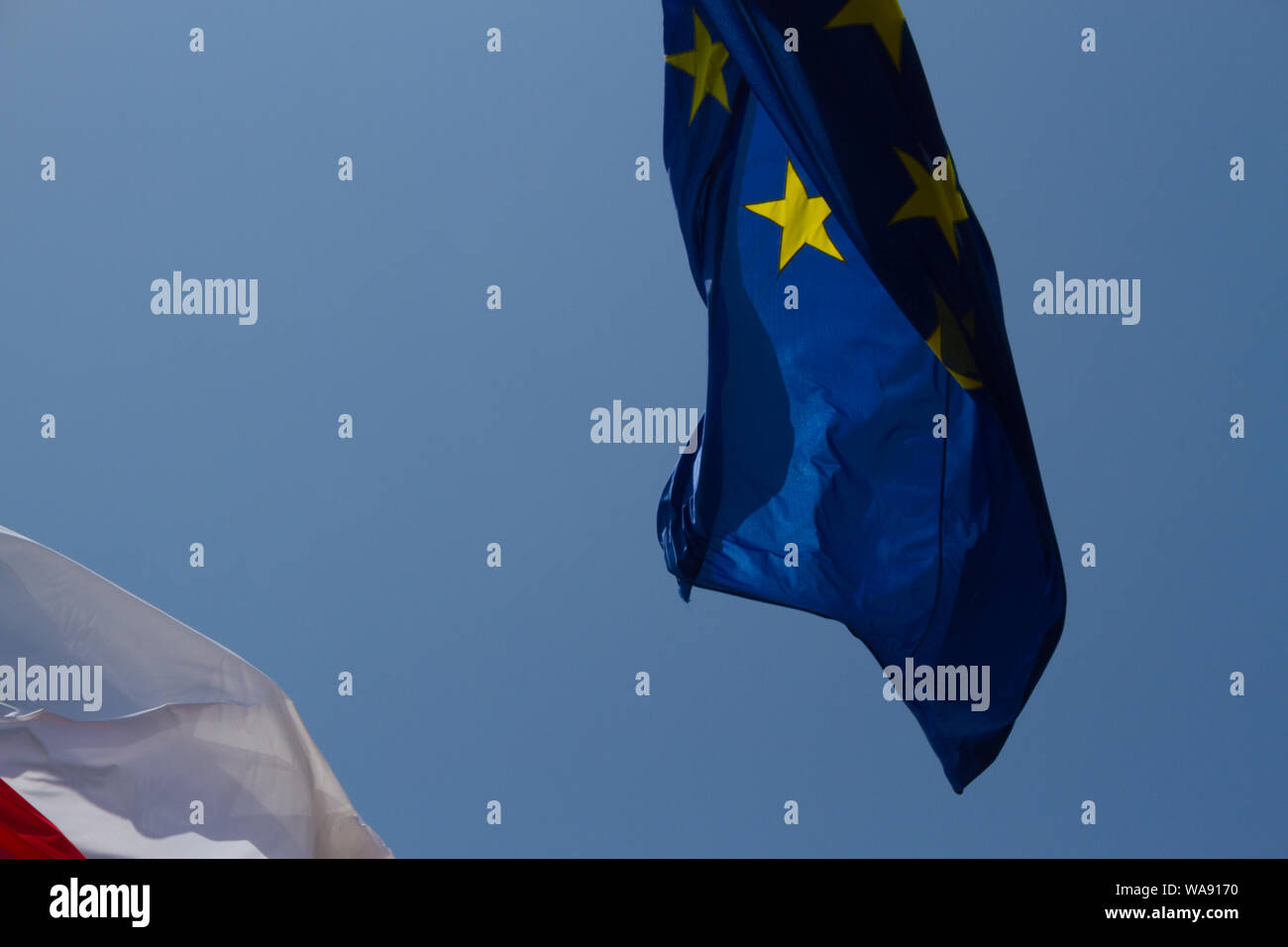 European Union flag on blue sky background Stock Photo - Alamy