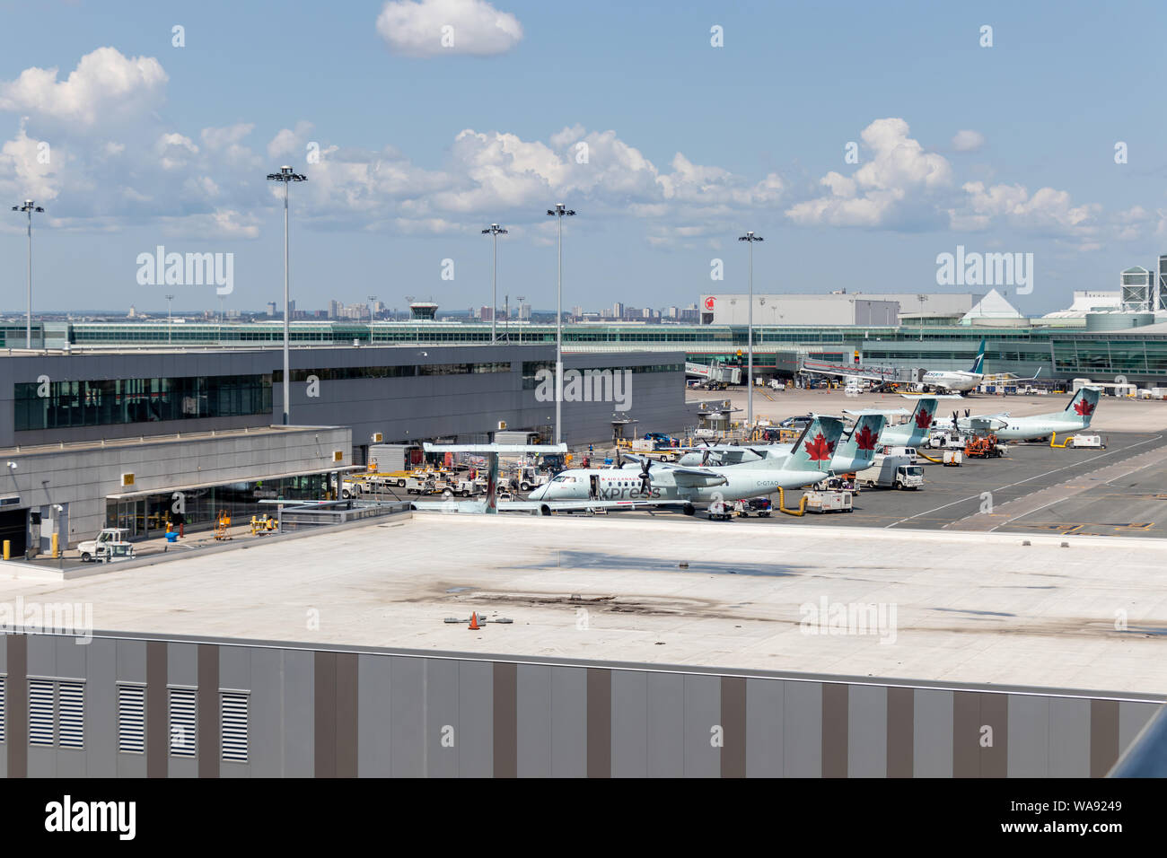 Air Canada and WestJet aircraft parked at gates at Toronto Pearson International Airport. Stock Photo
