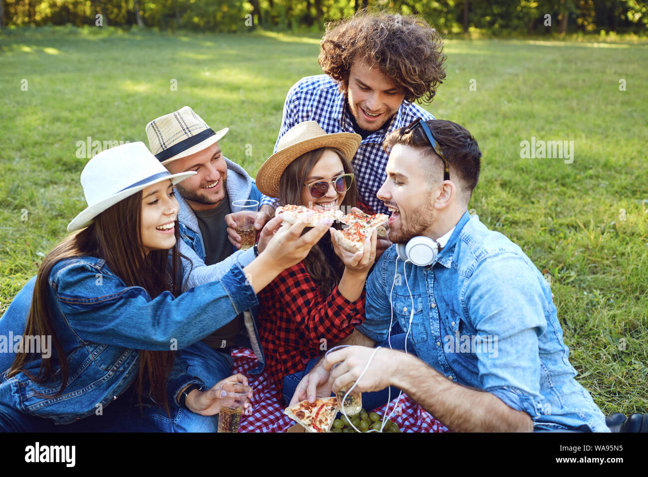 A group of young people having on a picnic in the park Stock Photo - Alamy