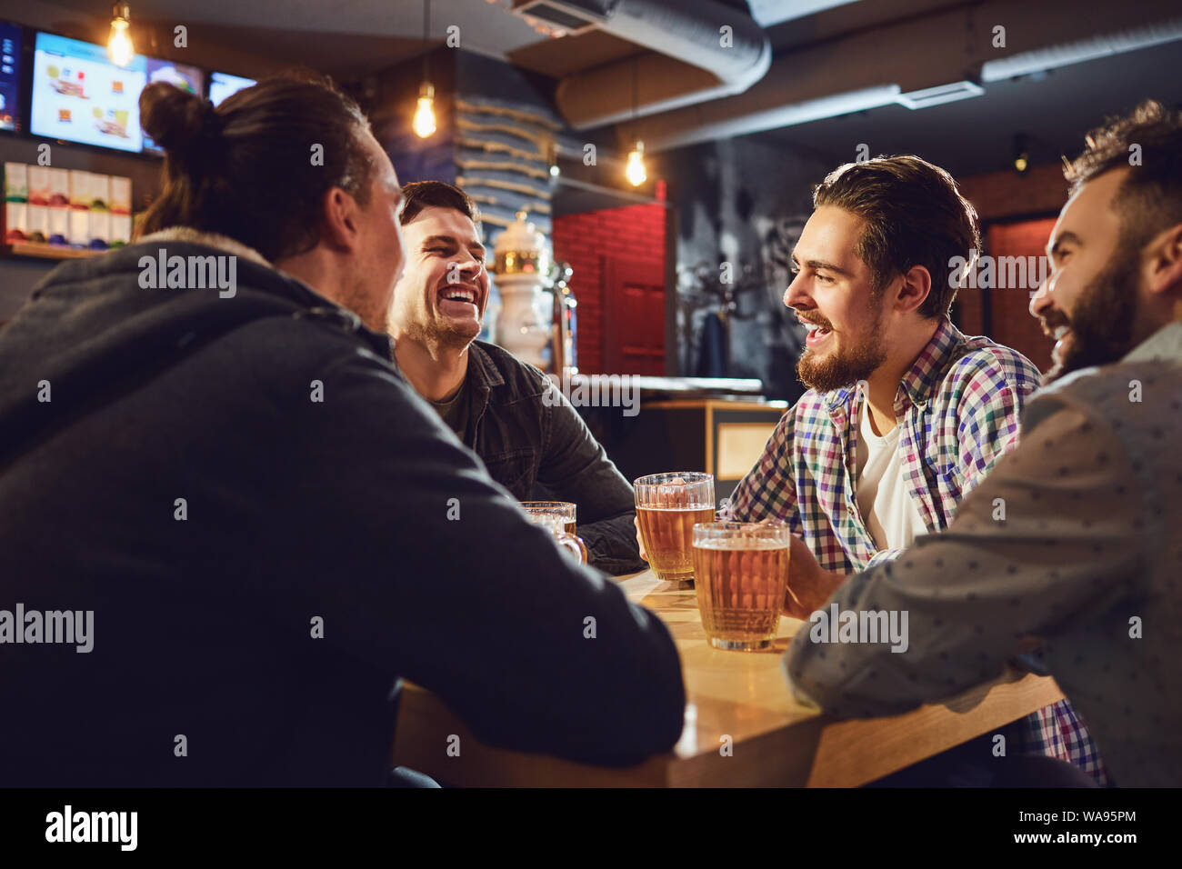 Friends talk, drink beer in a bar Stock Photo - Alamy