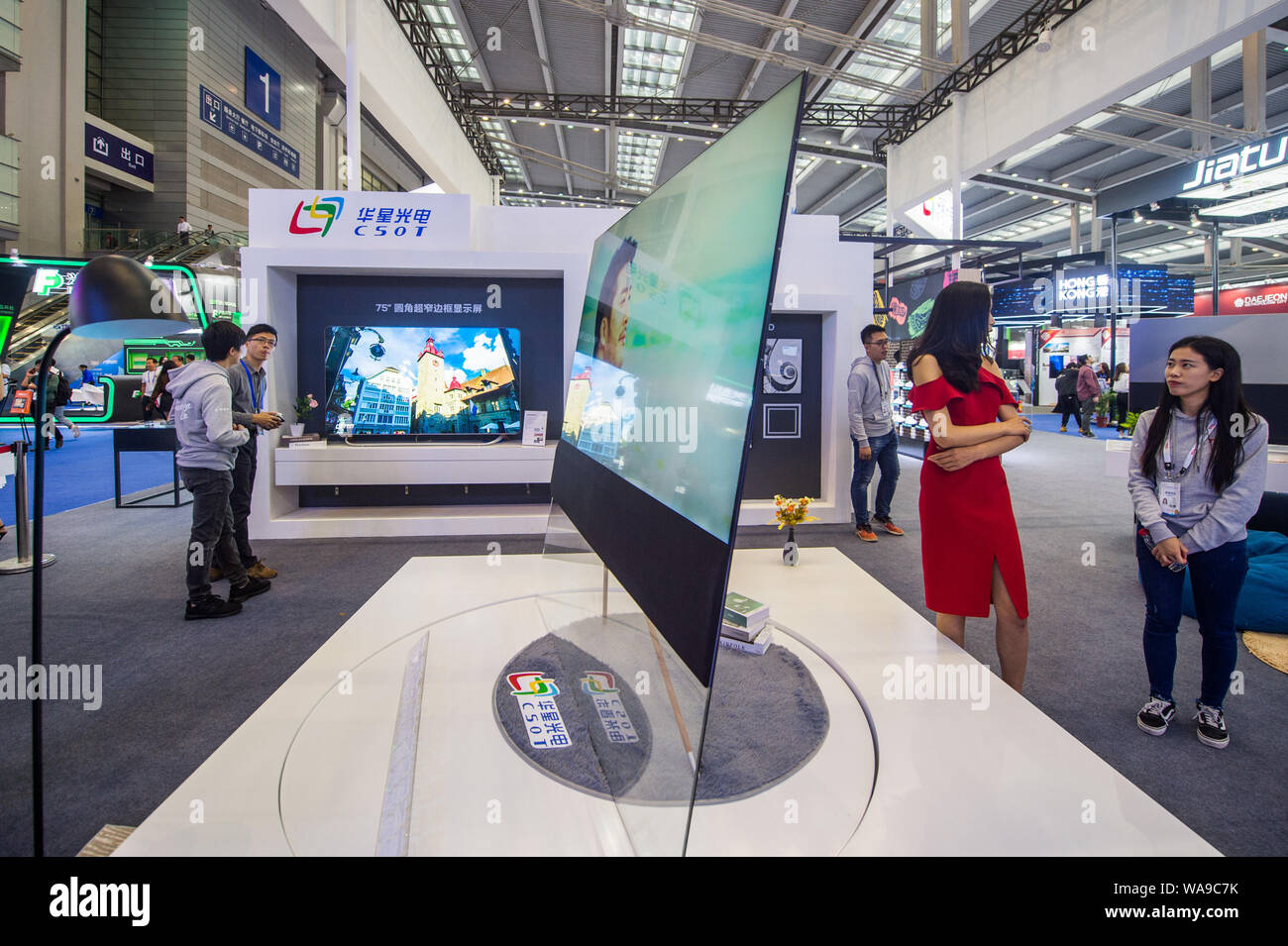 FILE--People visit the stand of Shenzhen China Star Optoelectronics Technology  Co Ltd (CSOT) in Shenzhen city, south China's Guangdong province, 14  November 2018. Behind Guangdong's thriving electronics industry are an  array of