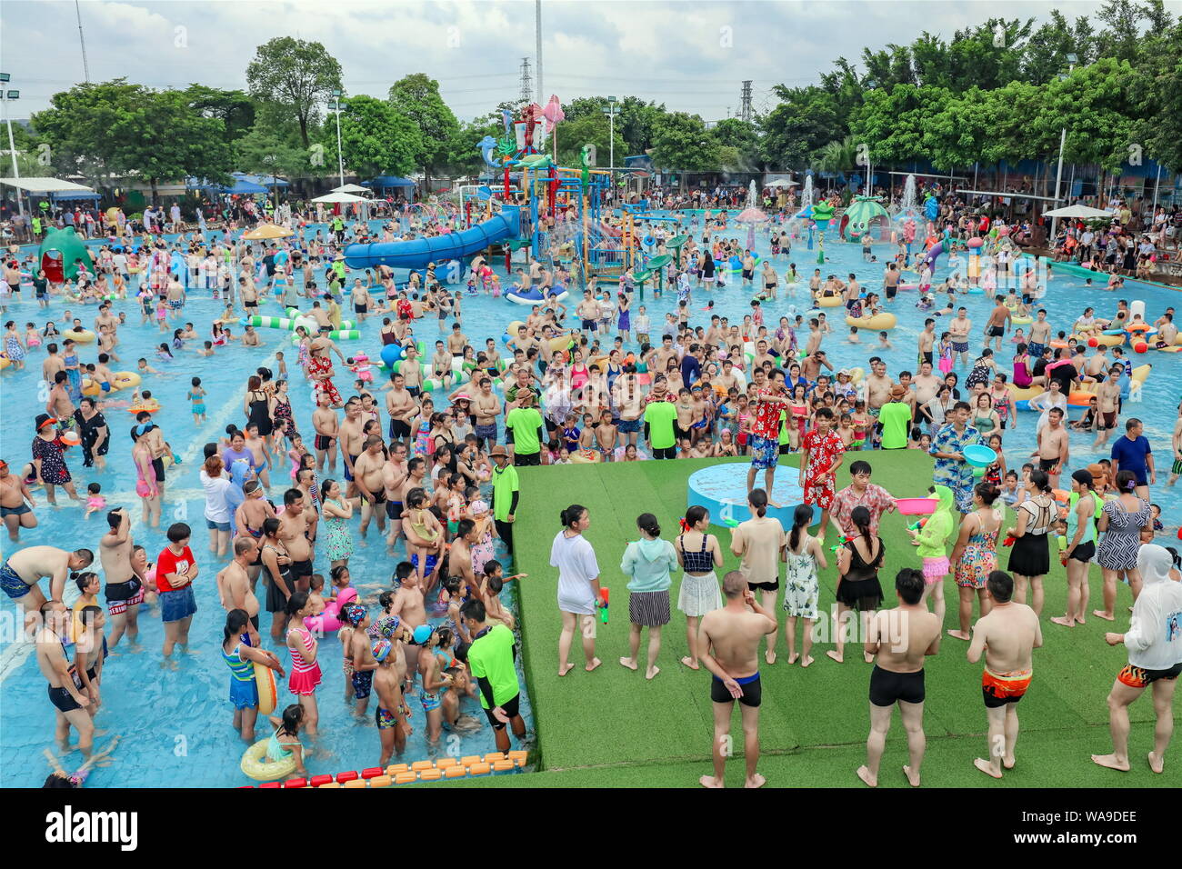 Chinese holidaymakers crowd a swimming pool at a water park on a