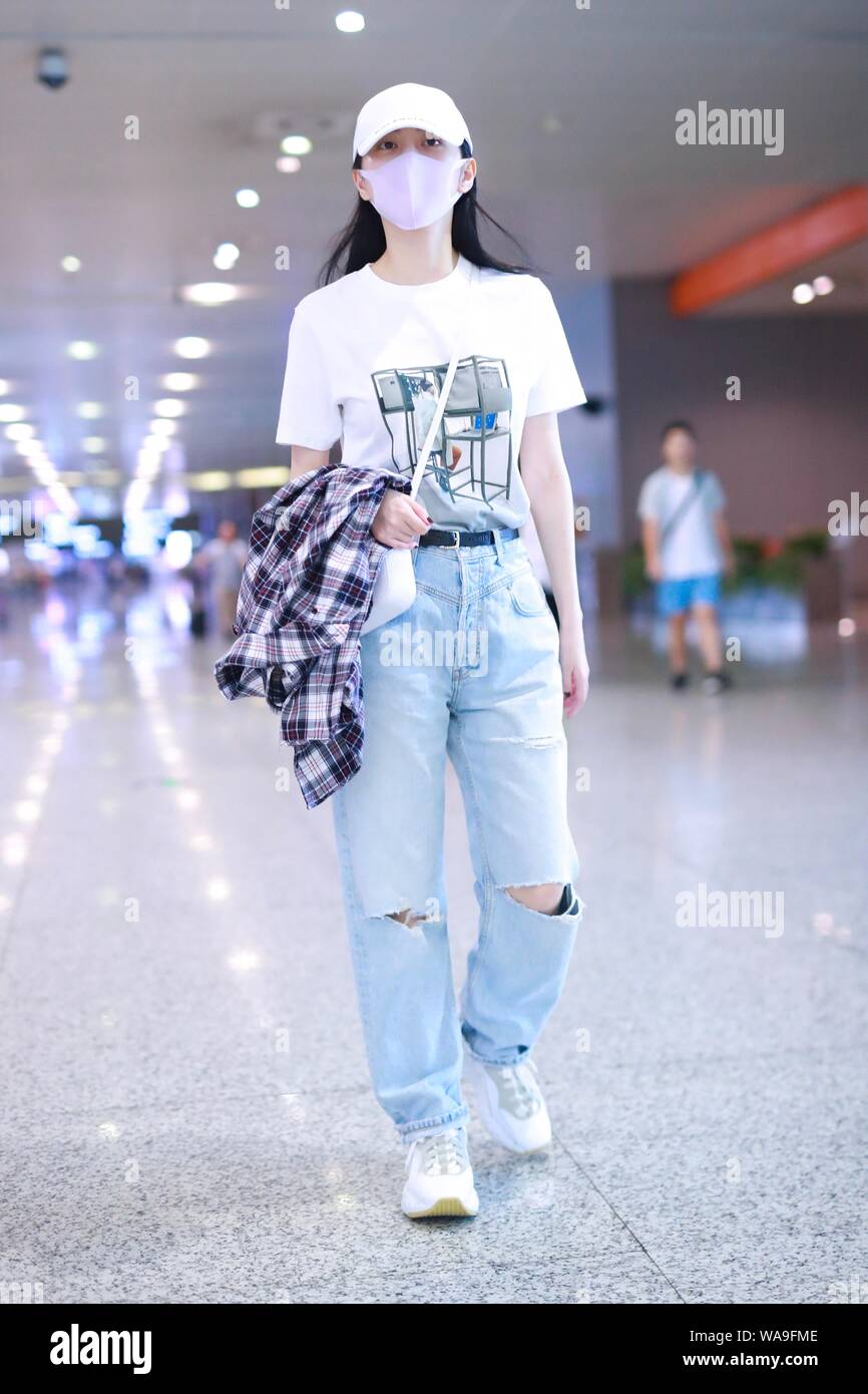 Chinese actress Jing Tian arrives at an airport after landing Shanghai, China, 29 July 2019. T-shirt: Off-White × Byredo Handbag & Hat: Balenciaga Stock Photo - Alamy