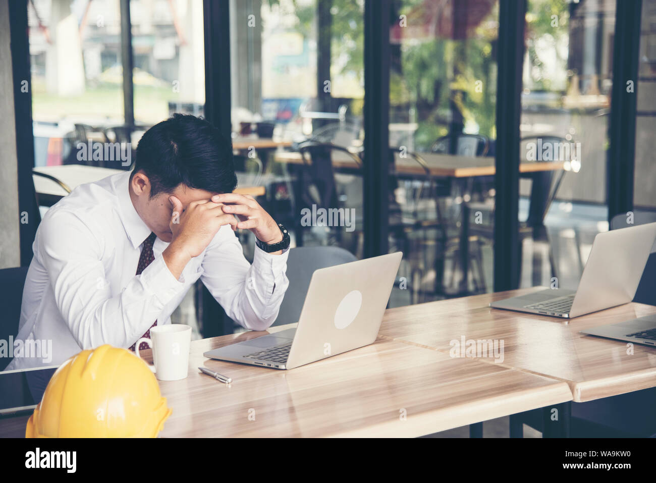 Handsome engineer working outdoor in the coffee shop. Stock Photo