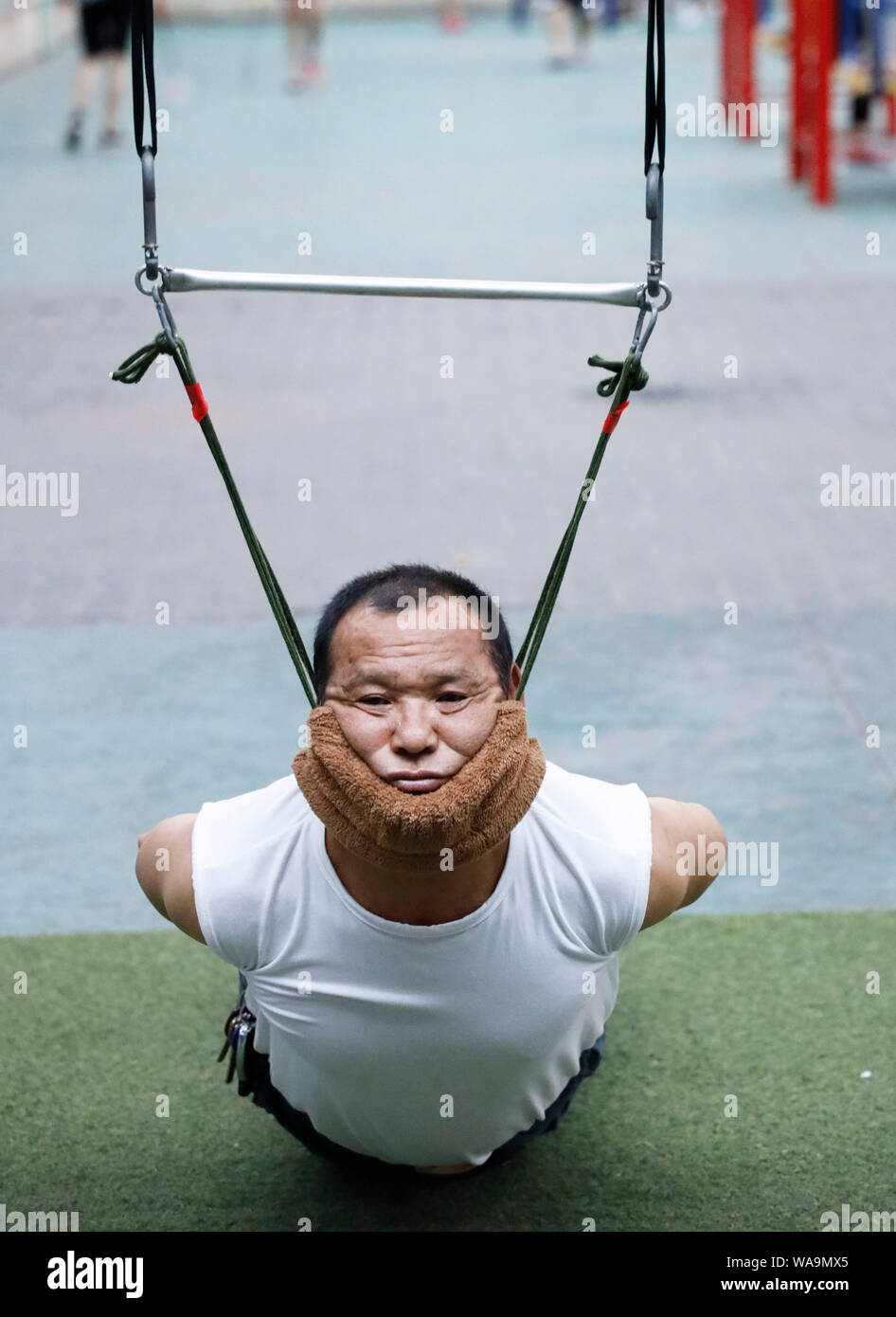 A group of exercisers do hanging-like exercise which is found capable of lessening and even curing cervical spondylosis in Shenyang city, Northeast Ch Stock Photo