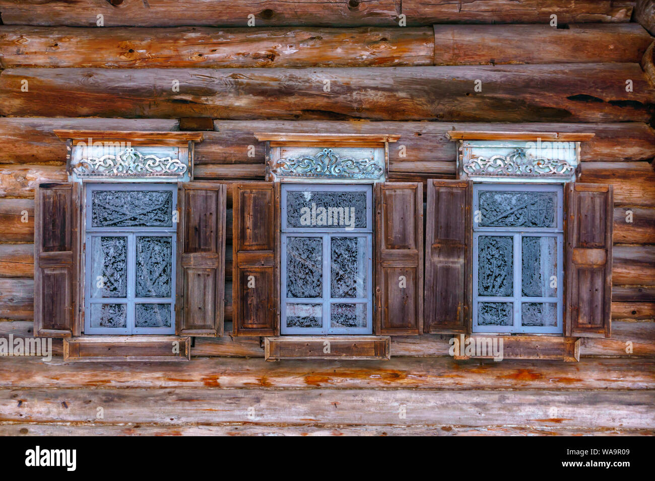 Timber Window Pattern three vintage windows with frosty patterns on glass in the log wall of ...