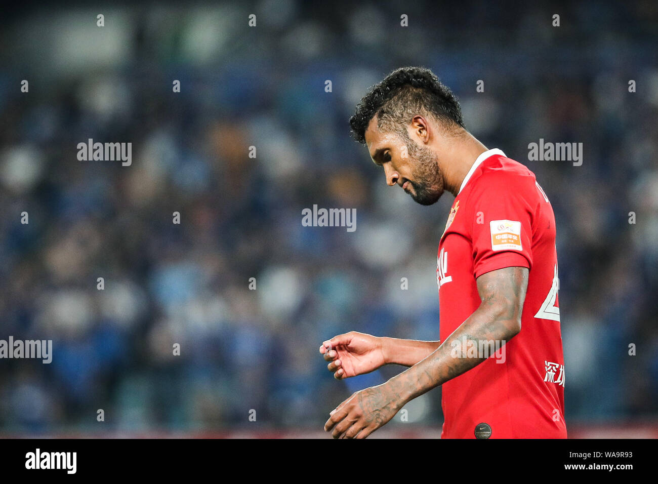 Brazilian-born Portuguese football player Dyego Sousa of Shenzhen FC reacts as he competes against Jiangsu Suning in their 20th round match during the Stock Photo