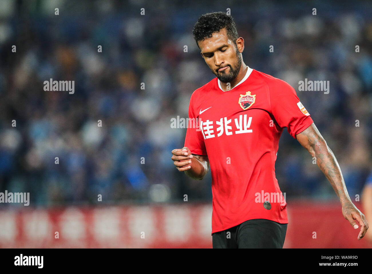 Brazilian-born Portuguese football player Dyego Sousa of Shenzhen FC reacts as he competes against Jiangsu Suning in their 20th round match during the Stock Photo