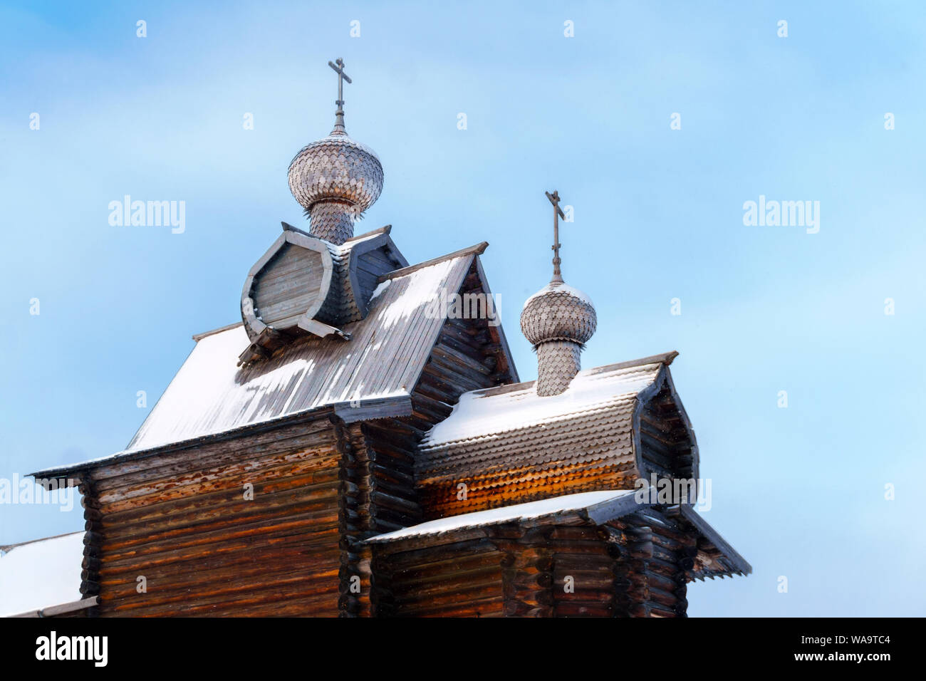 domes with a crosses of old entirely wooden Orthodox church against the ...