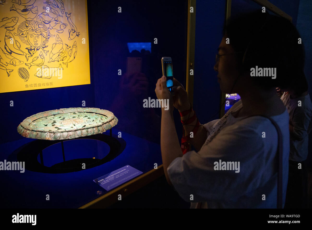 A visitor views treasures and relics from Afghan national treasures during an exhibition at a museum in Nanjing city, east China's Jiangsu province, 8 Stock Photo