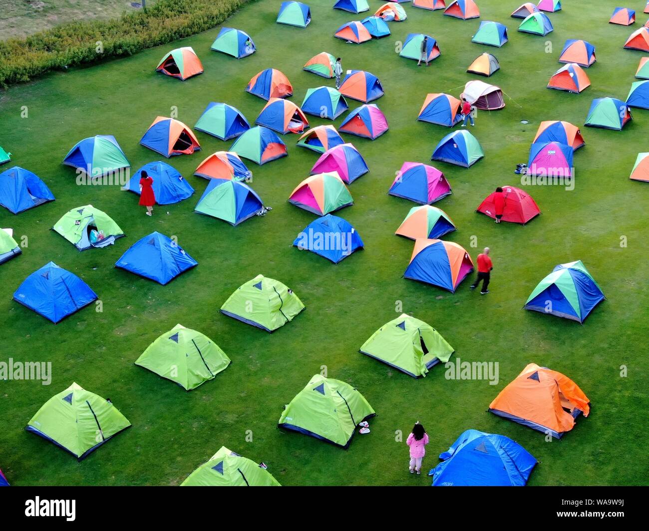 Thousands of local residents build colorful tents at the Funiu Mountain, one of the Top 100 best summer resort mountains in China, to cool off in Nany Stock Photo