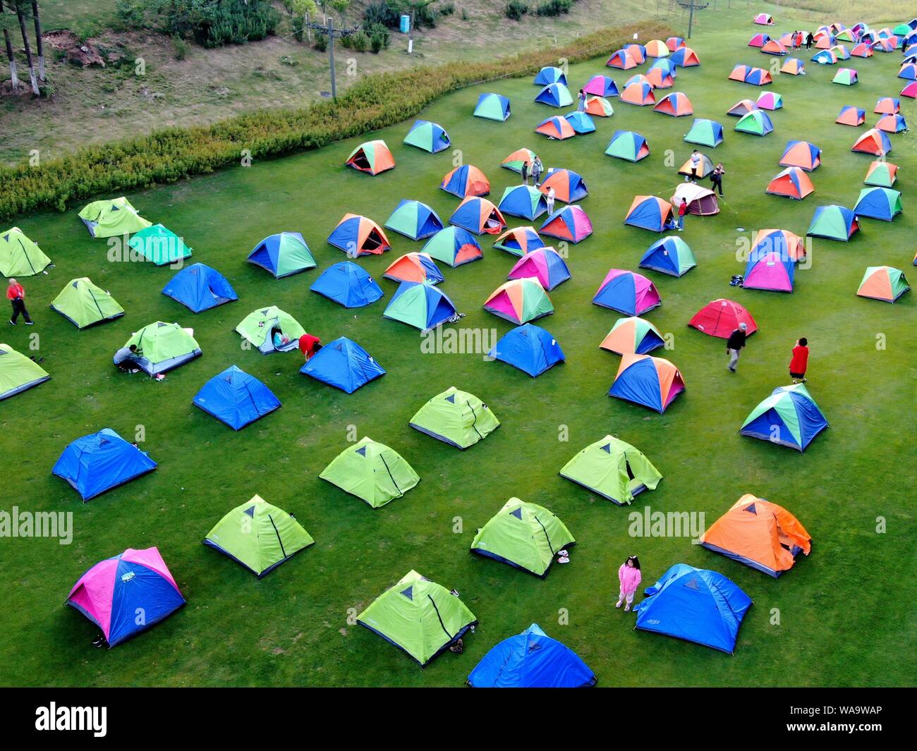 Thousands of local residents build colorful tents at the Funiu Mountain, one of the Top 100 best summer resort mountains in China, to cool off in Nany Stock Photo