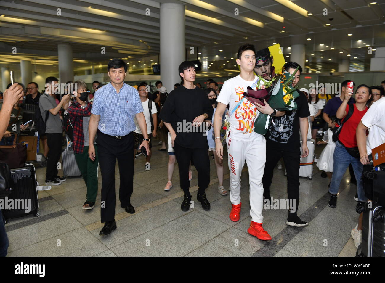 Chinese swimming Olympic champion Sun Yang is surrounded by crowds of ...