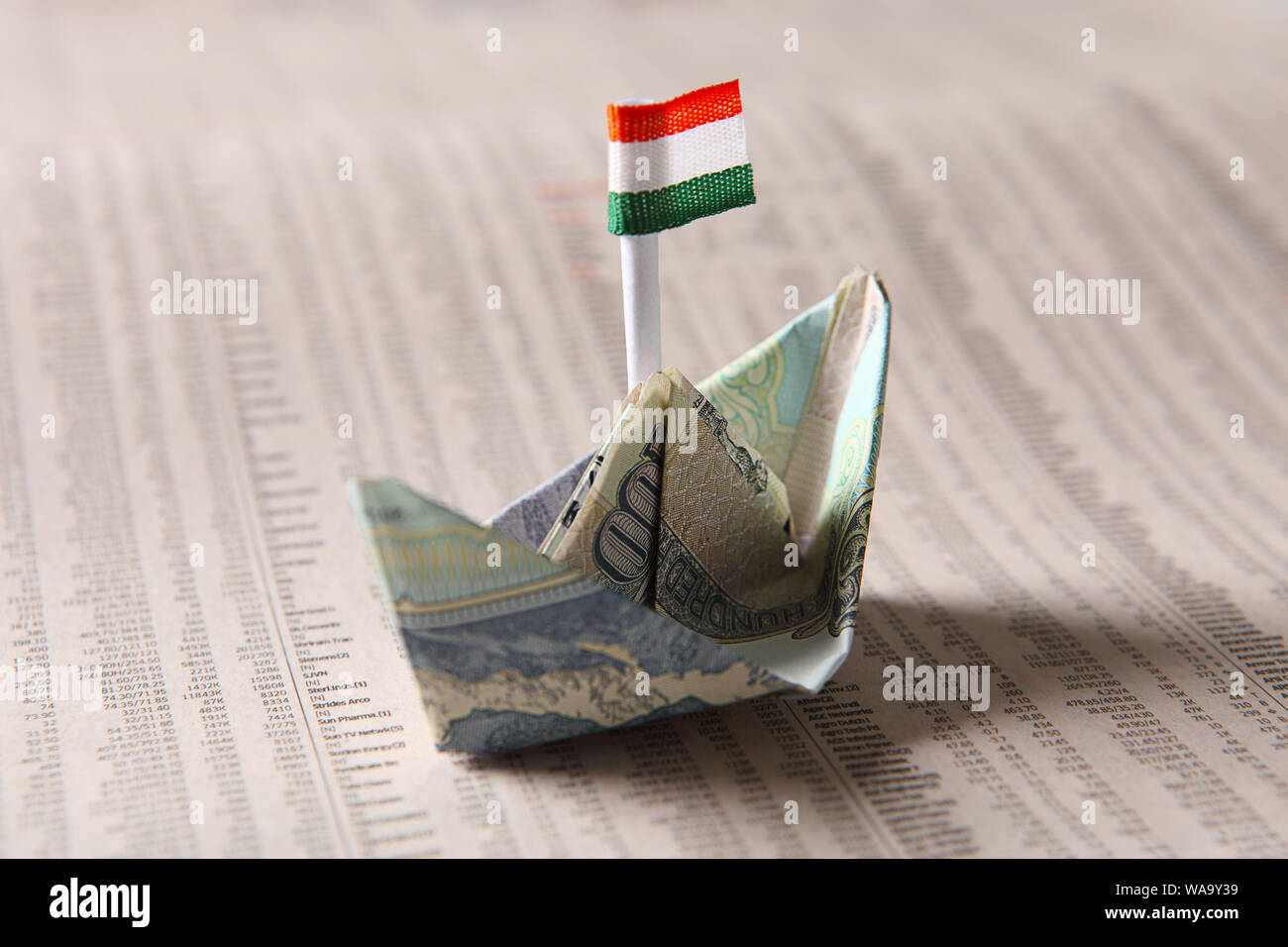 Indian banknote boat sailing on financial newspaper Stock Photo Alamy