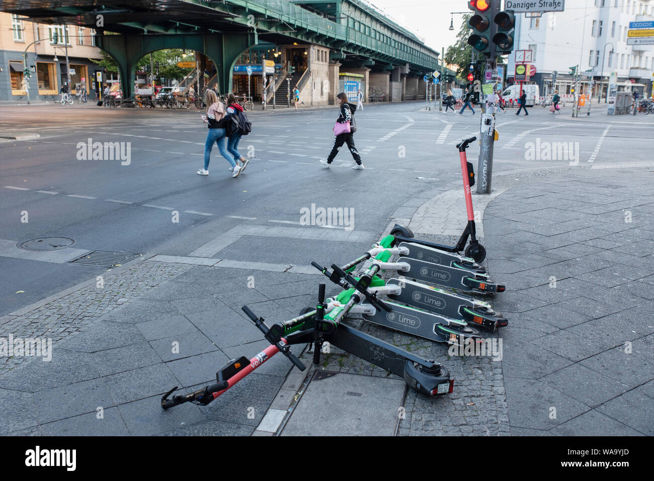 One early morning, recently arrived in Berlin, Uber-owned LIME and VOI  e-scooters lay on the pavement, Berlin Stock Photo - Alamy