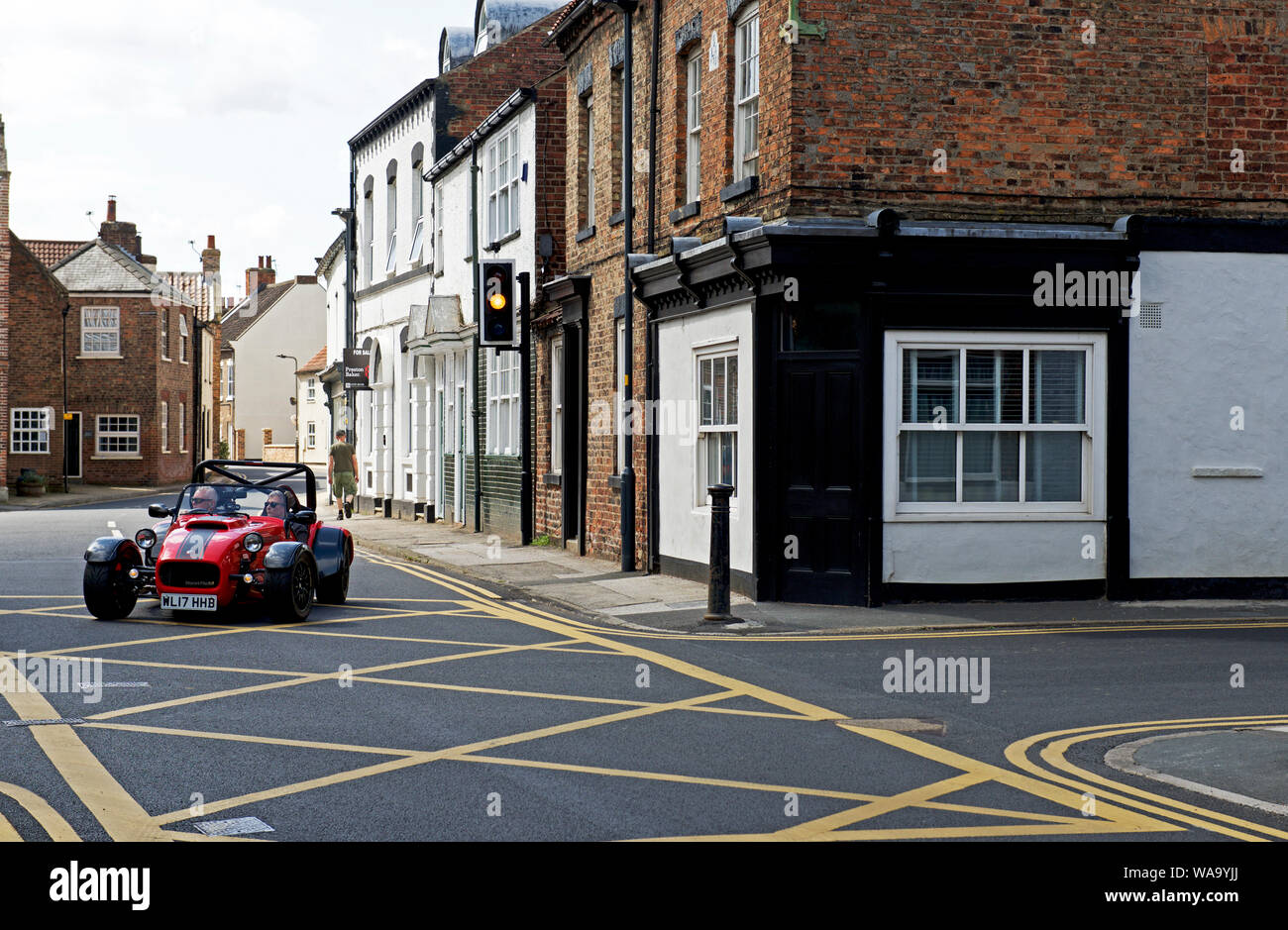 Caterham Super 7 sports car and yellow box junction in the village of Cawood, North Yorkshire, England UK Stock Photo